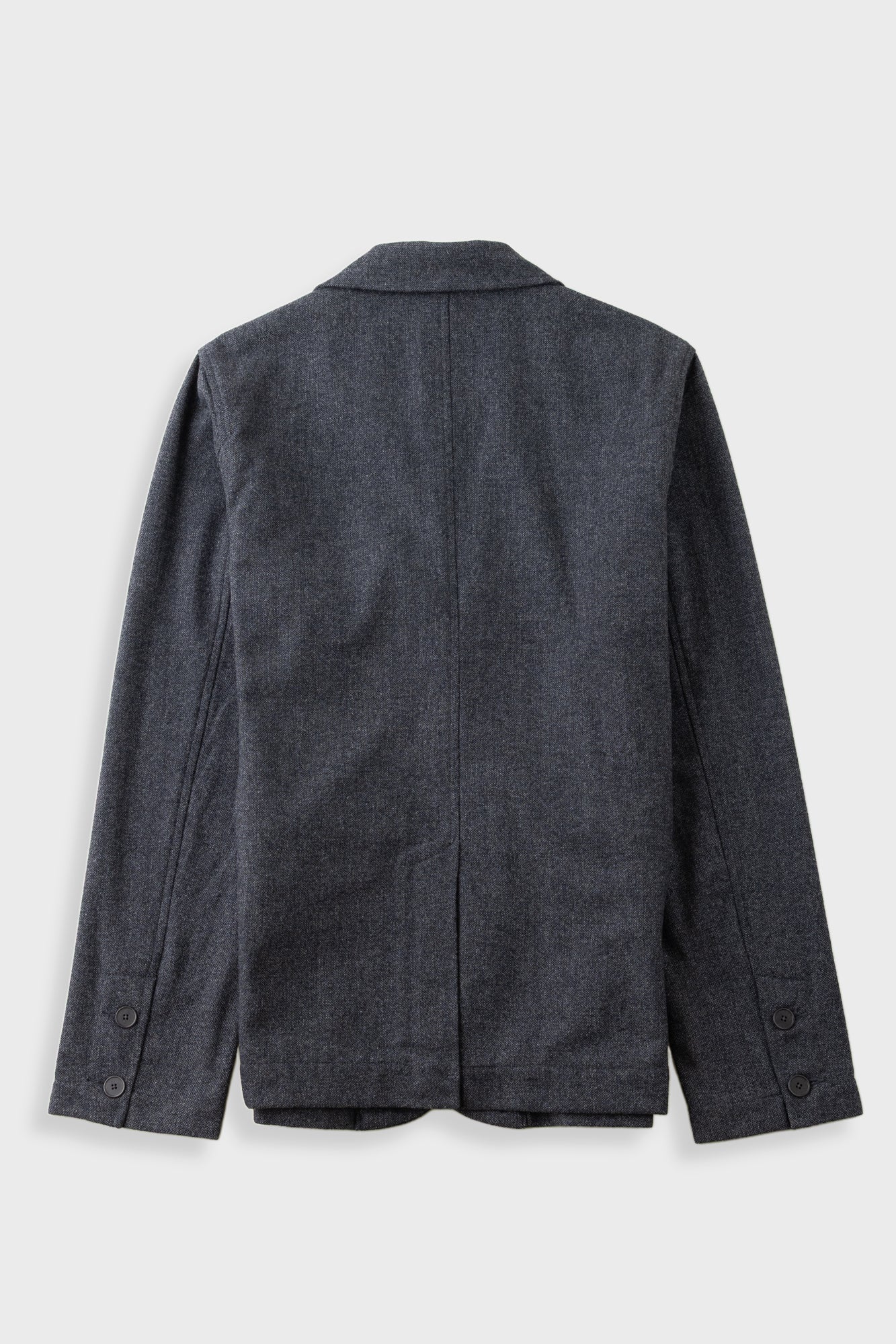 A dark charcoal gray wool blazer shown from the back, featuring a classic collar, long sleeves with button cuffs, and a clean silhouette on a light gray background.