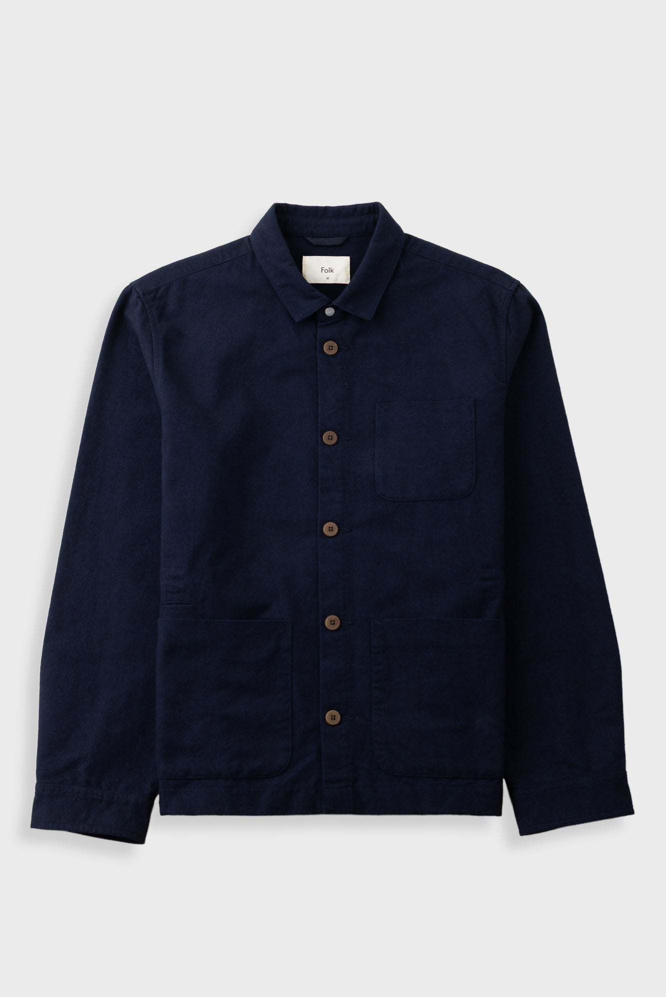 A dark navy blue corduroy utility jacket with brown buttons, a pointed collar, and a chest pocket, displayed flat against a light gray background.