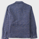 A textured blue long-sleeve shirt jacket shown from the back, featuring a subtle heathered pattern with fine orange and yellow flecks, set against a light gray background.