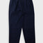 A pair of dark navy blue trousers with front pleats, laid flat against a light gray background.