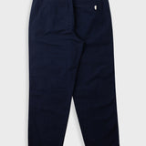 Navy pants worn by a person on a white background