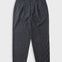 Grey trousers laid flat against a light grey background