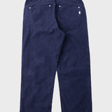 A pair of dark navy blue corduroy pants shown from the back, featuring a button waistband, belt loops, and back pockets, on a light gray background.