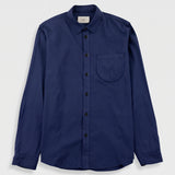 A navy blue long-sleeve button-up shirt with a single chest pocket, displayed flat against a light gray background.