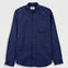 A navy blue long-sleeve button-up shirt with a single chest pocket, displayed flat against a light gray background.