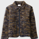 A zip-up jacket featuring a textured, marled tweed pattern in navy blue, brown, and gold. It has a stand-up collar, a front zipper, and two large front patch pockets with dark piping, shown against a light gray background.