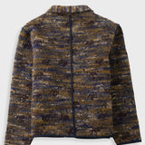 A zip-up jacket featuring a textured, marled tweed pattern in navy blue, brown, and gold. It has a stand-up collar, a front zipper, and two large front patch pockets with dark piping, shown against a light gray background.