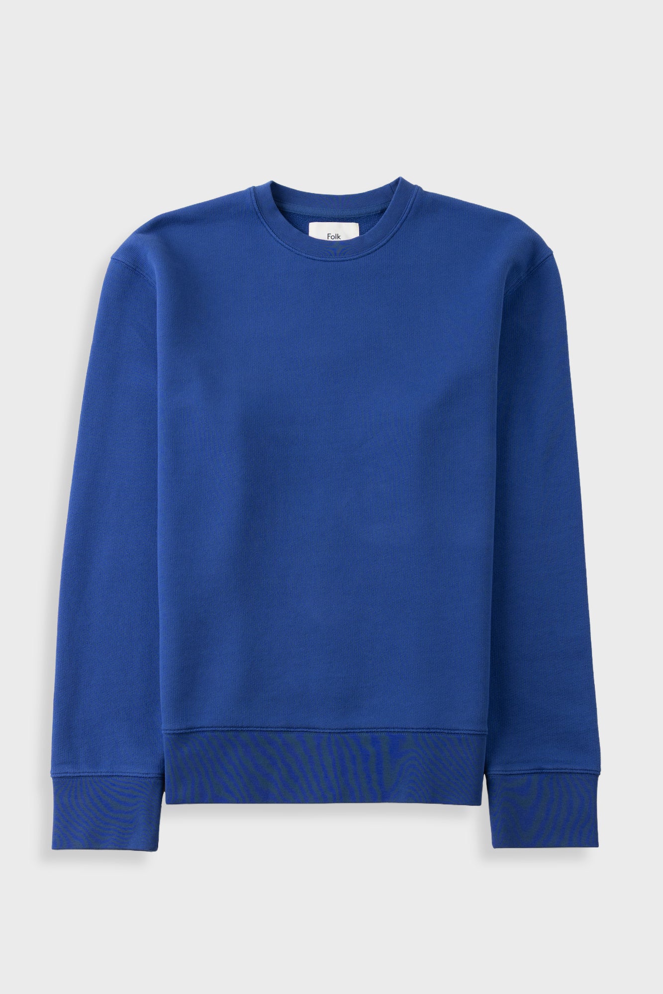 A royal blue crewneck sweatshirt with ribbed cuffs and hem, displayed flat against a light gray background.