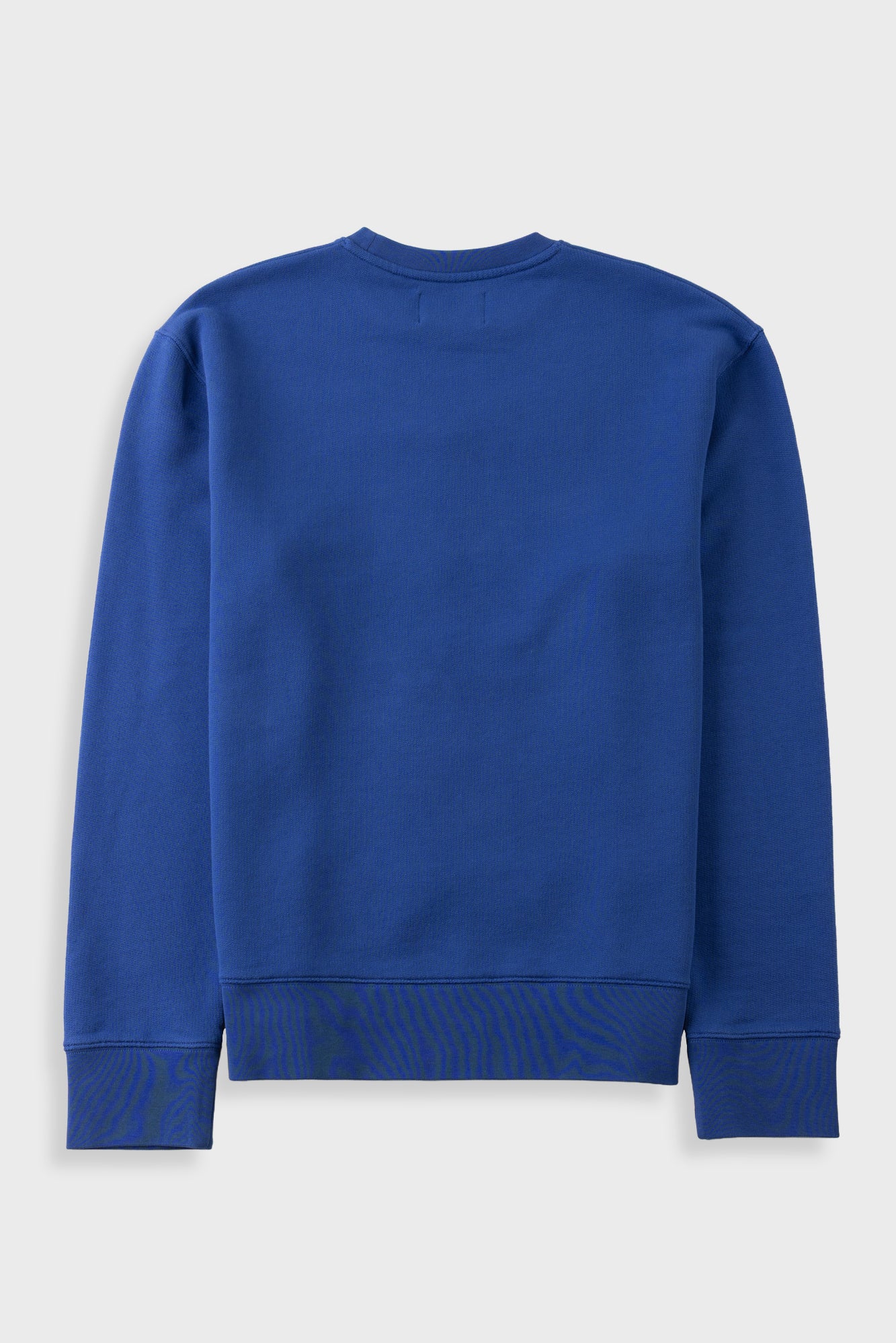 A royal blue long-sleeve crewneck sweatshirt shown from the back, laid flat against a light gray background.