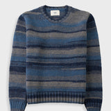 A crewneck knit sweater with horizontal stripes in shades of blue, navy, and gray, displayed flat against a light gray background.