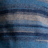 Close-up of a knitted fabric with horizontal stripes in shades of blue, navy, and gray.
