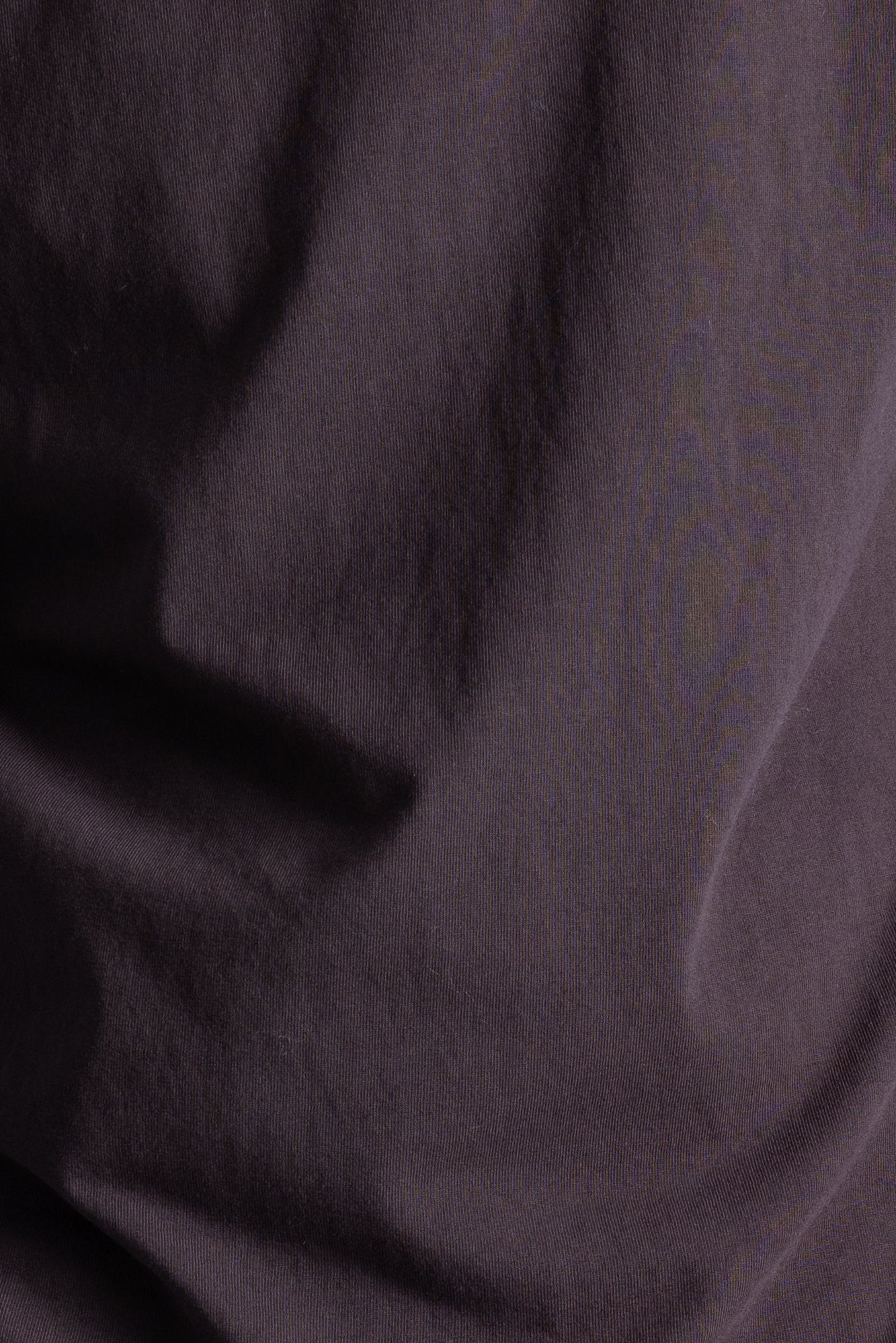 Close up of dark brown cotton fabric.