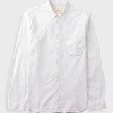 White cotton dress shirt with chest pocket laid flat against a grey background