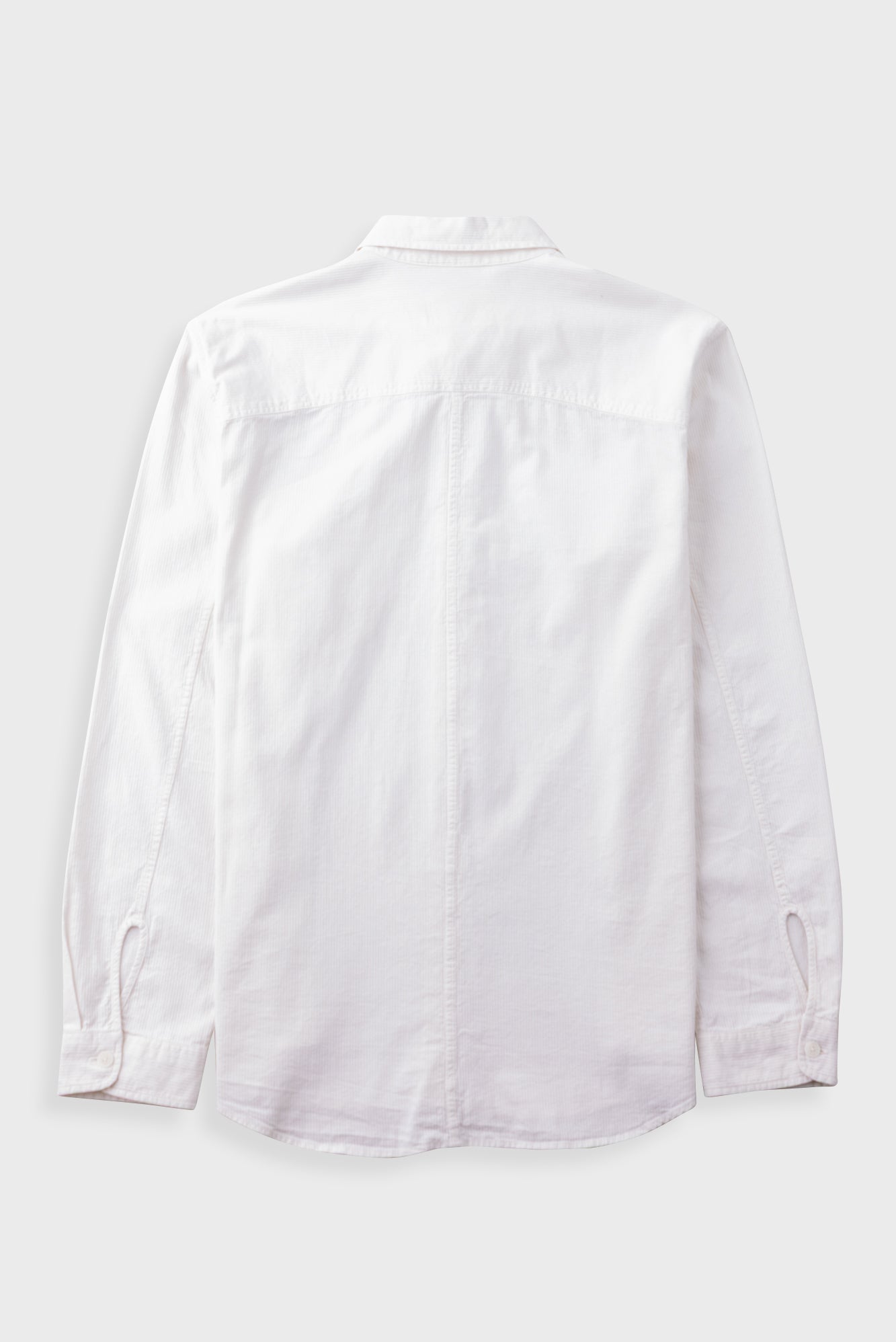 A white long-sleeve button-up shirt shown from the back, laid flat against a light gray background.