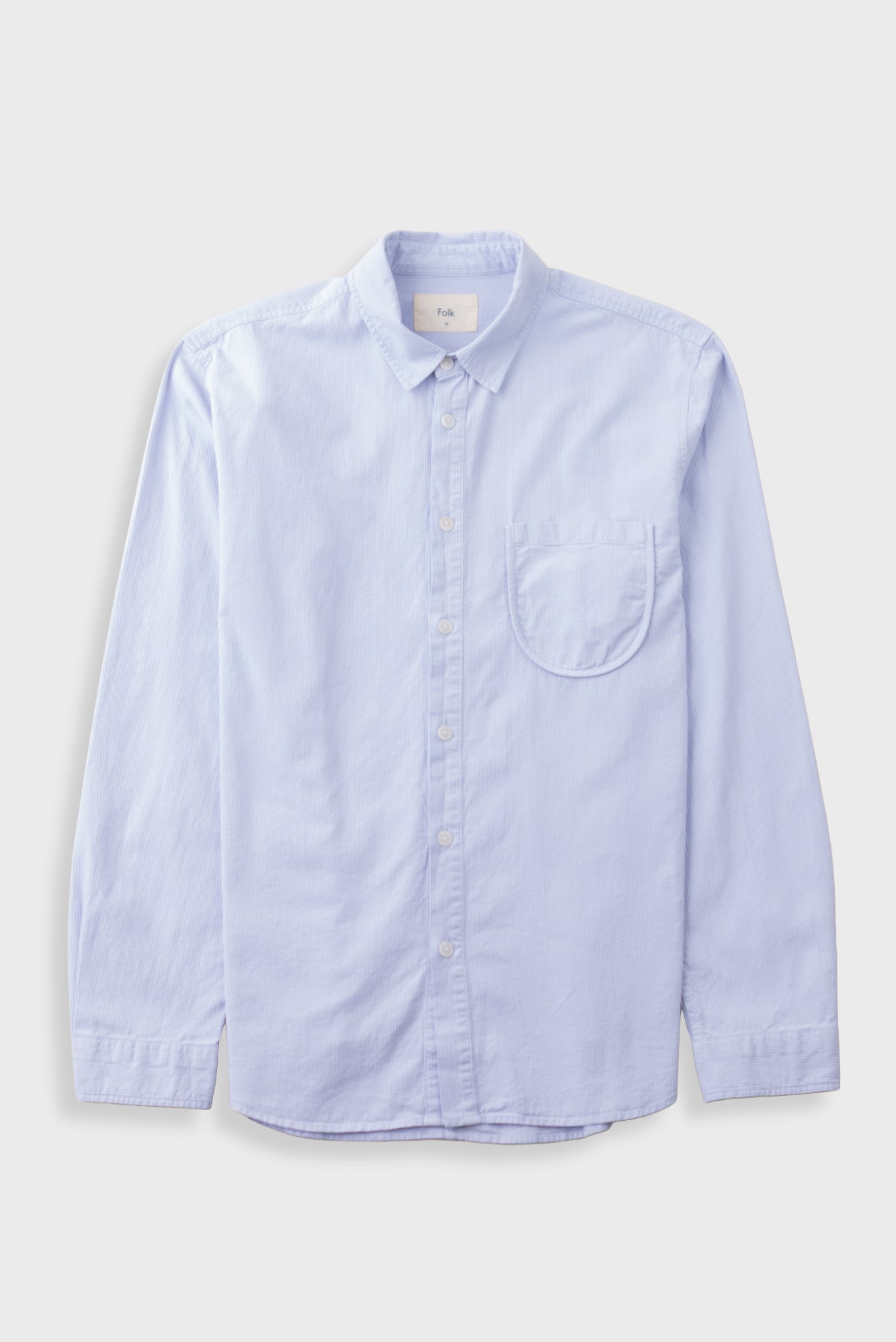 Light blue shirt laid flat against a light grey background