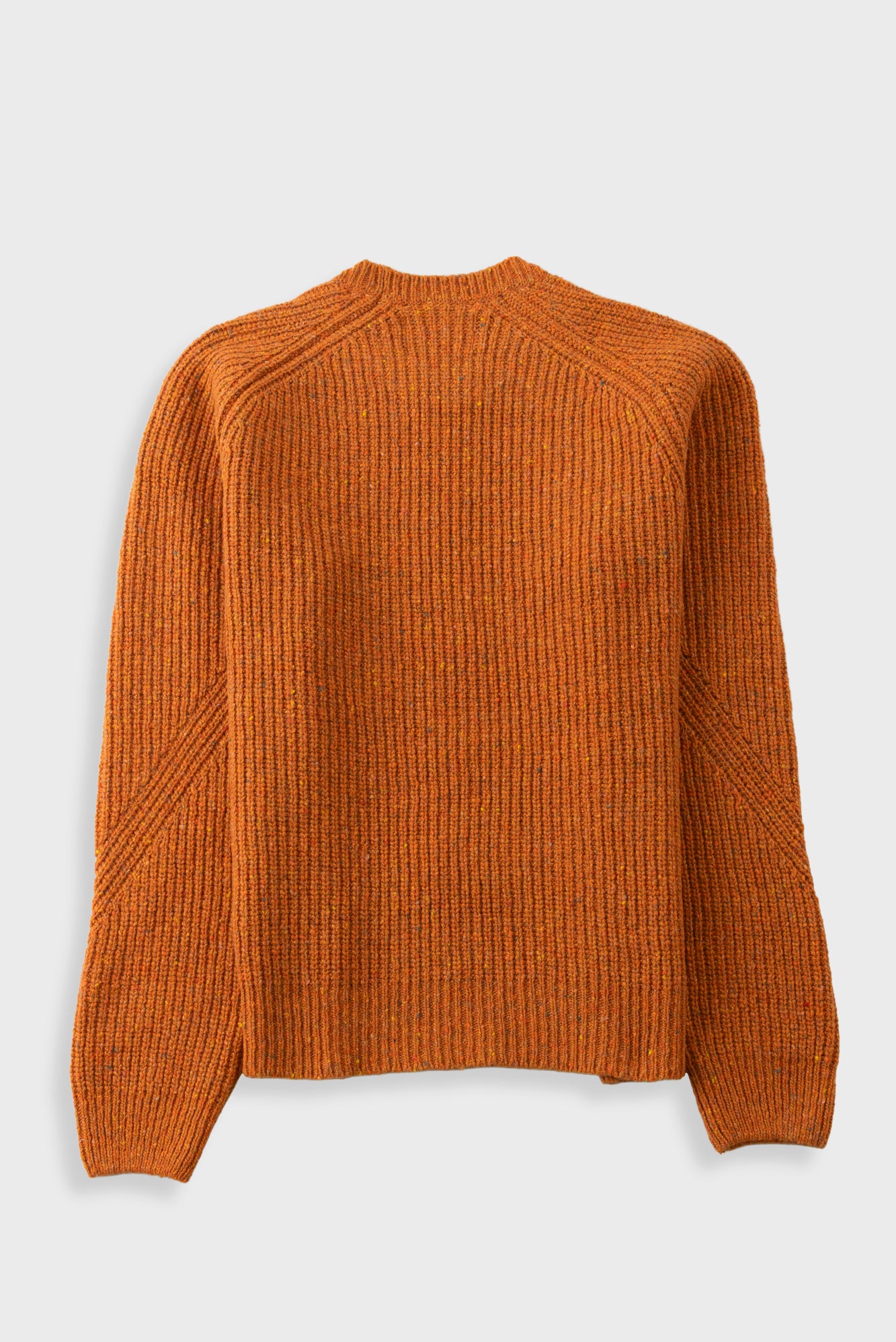 An orange ribbed knit sweater with long raglan sleeves, shown from the back against a light gray background.