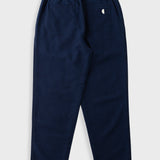 A pair of navy blue pants with an elastic waistband and a small white embroidered logo on the back pocket, shown against a light gray background.