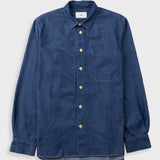 A dark blue denim long-sleeve button-up shirt with a chest pocket, laid flat against a light gray background.