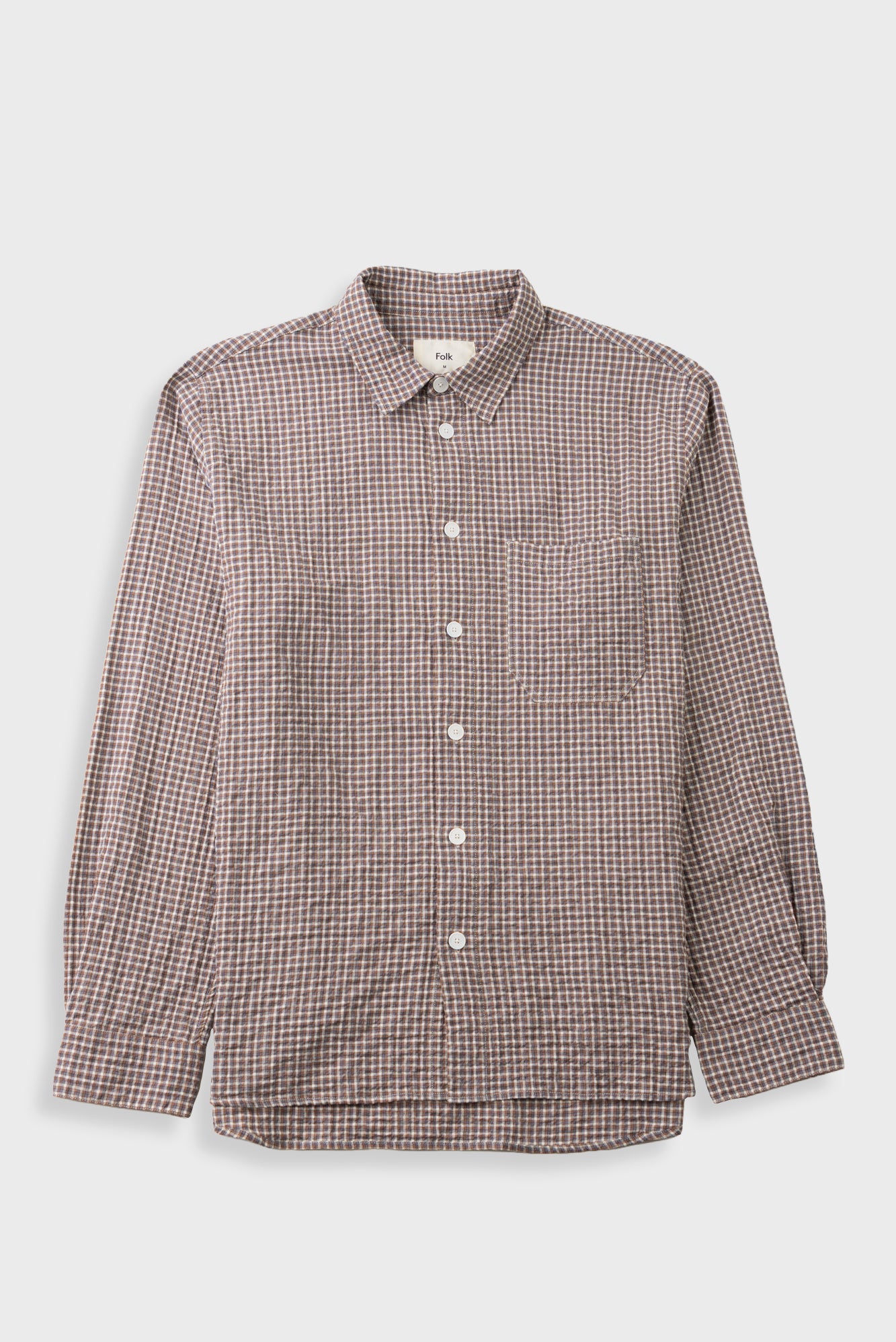A long-sleeve button-up shirt with a small-scale brown and white checkered pattern, featuring a classic collar, white buttons, and a chest pocket, displayed against a light gray background.