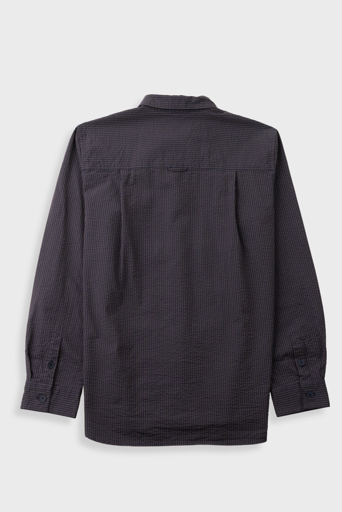 Textured brown striped shirt laid flat against a grey backdrop