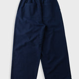 A pair of navy blue cropped pants with an elastic waistband and two back patch pockets, shown from the back on a light gray background.