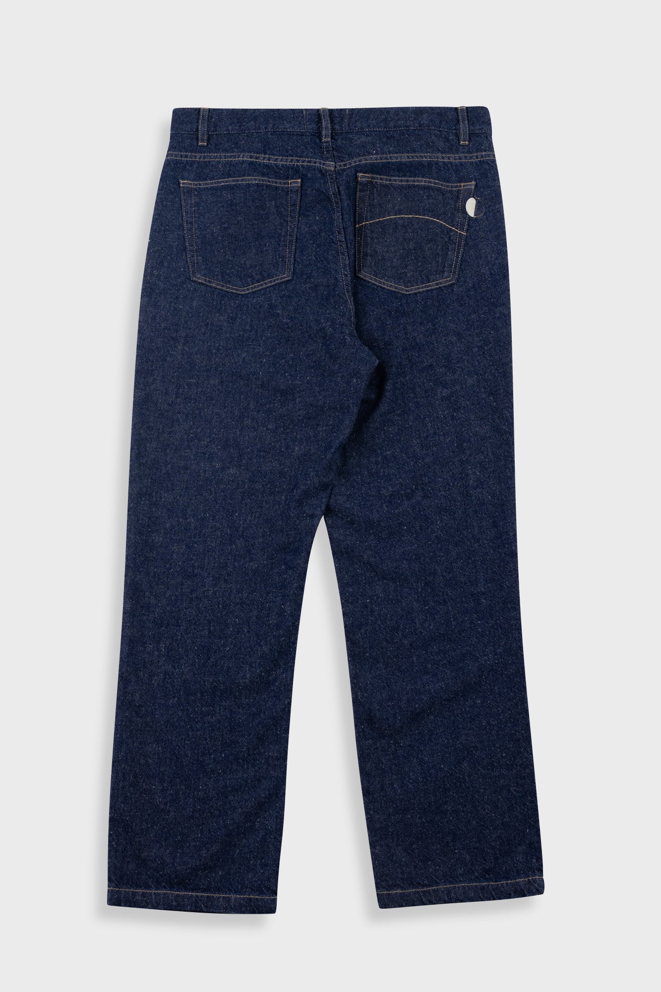 Back view of dark blue jeans on a white background