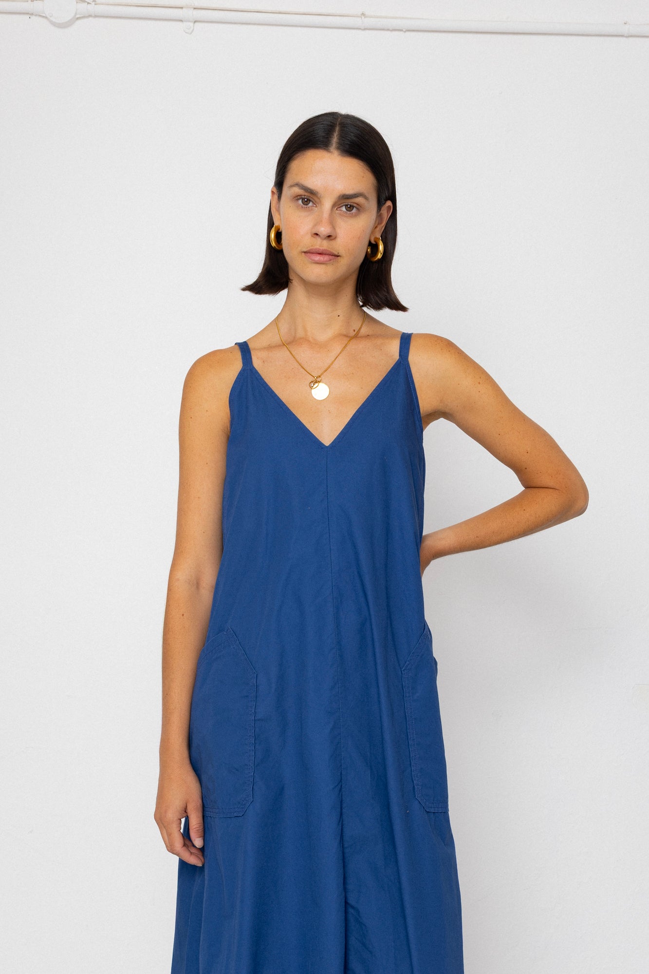 Woman wearing a blue dress against a white background