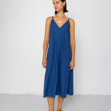 Woman wearing a blue dress against a white background
