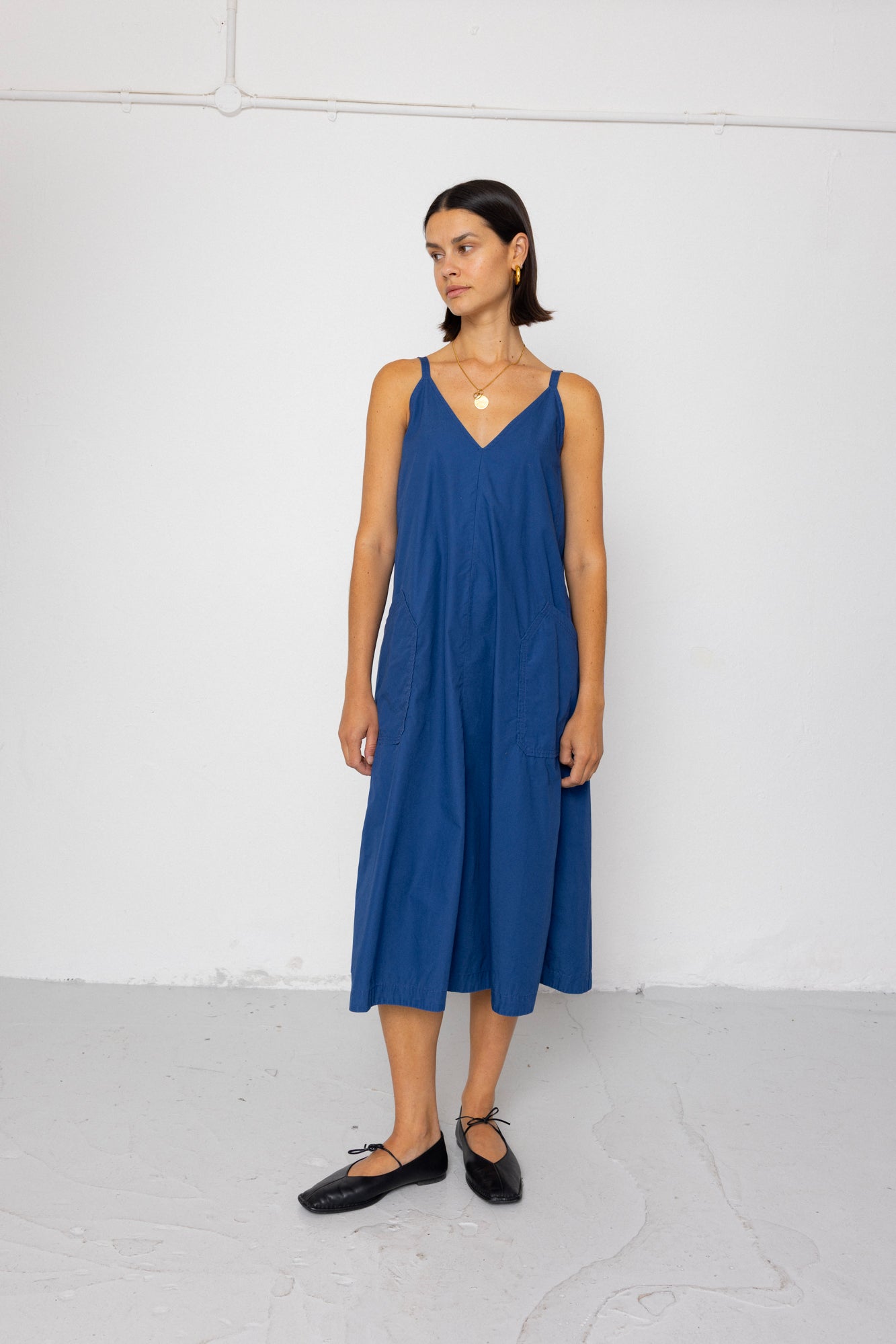 Woman wearing a blue dress against a white background
