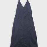 Navy blue dress with thin straps on a light gray background