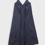 Black dress with straps on a light gray background