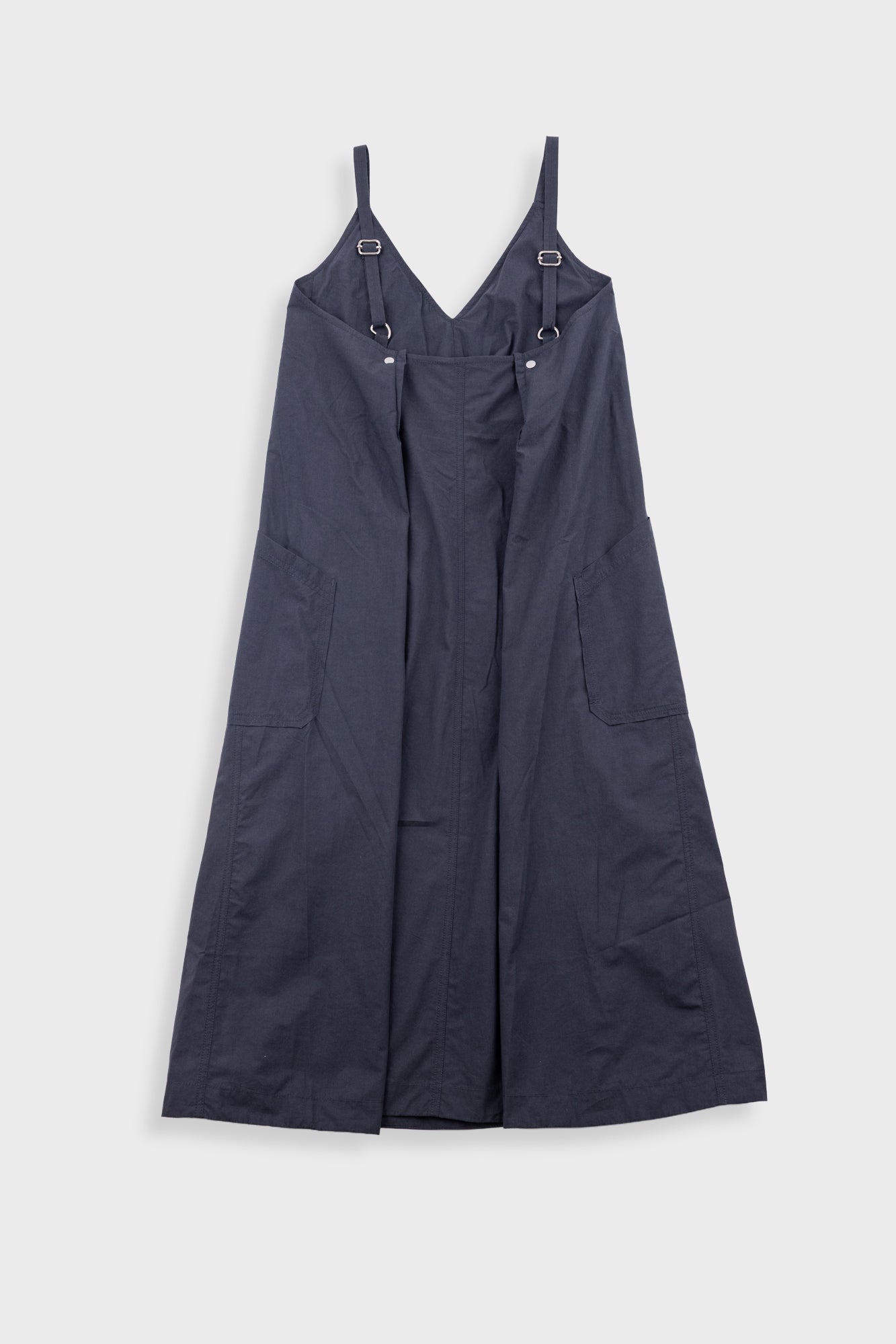 Black dress with straps on a light gray background