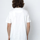 Person wearing a plain white t-shirt against a white background