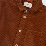 Brown corduroy shirt with a visible brand label on a white background