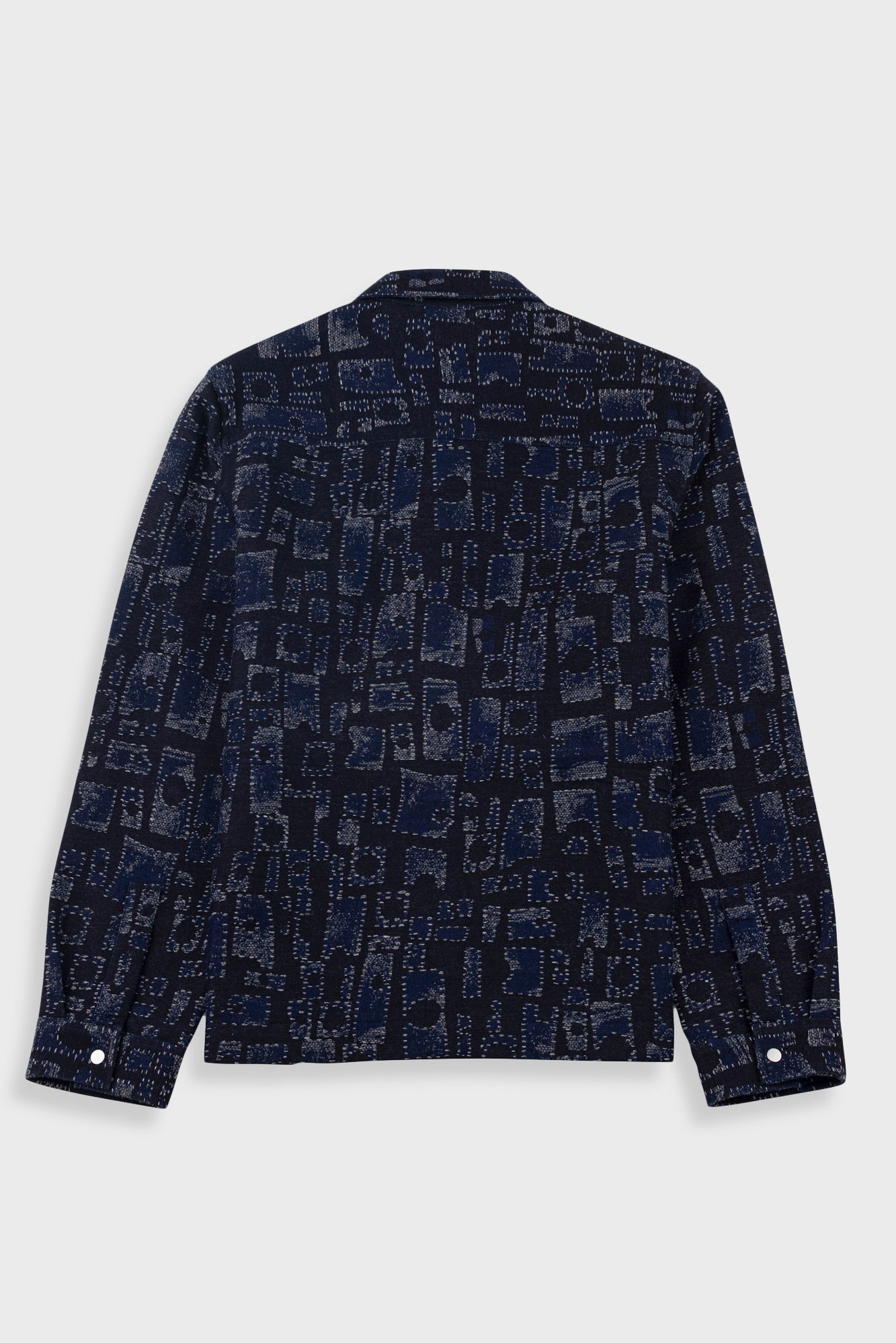 Dark blue patterned shirt on a light gray background