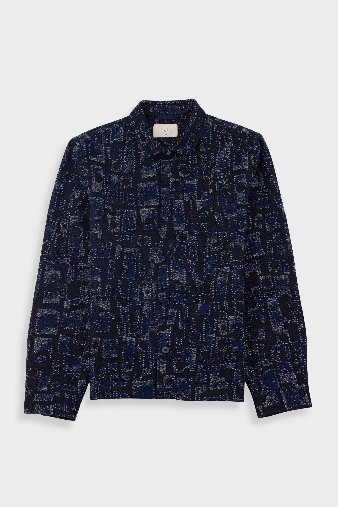 Navy patterned shirt on a light gray background