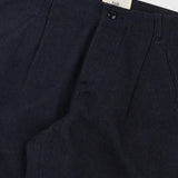 Dark black pants with a brand label on a light gray background