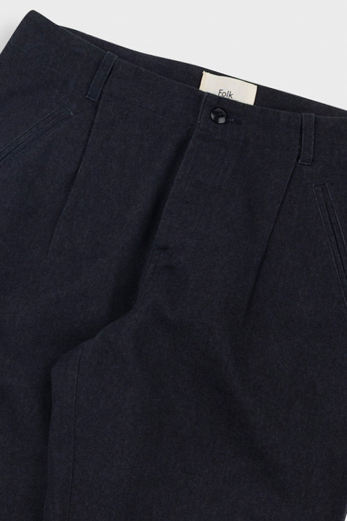 Dark black pants with a brand label on a light gray background