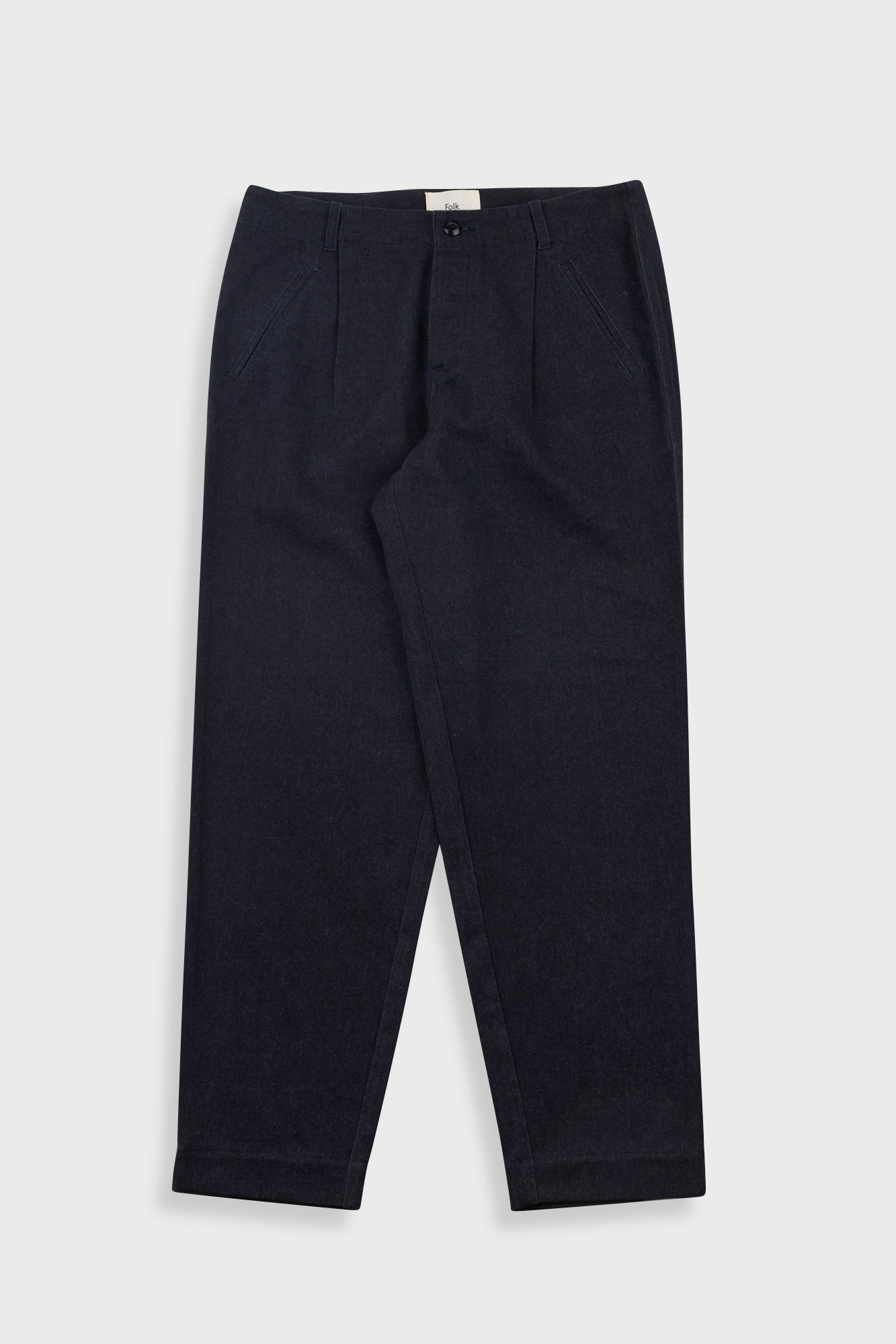 Pair of black trousers on a white background
