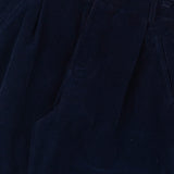 Navy blue pleated pants with a button on a white background