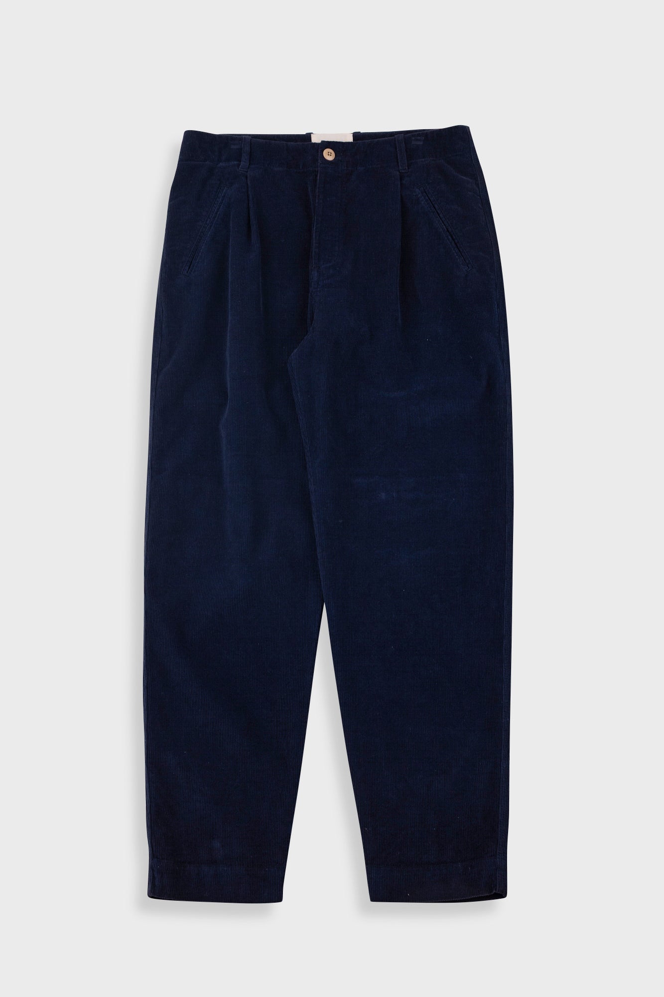 Navy blue corduroy pants on a light gray background