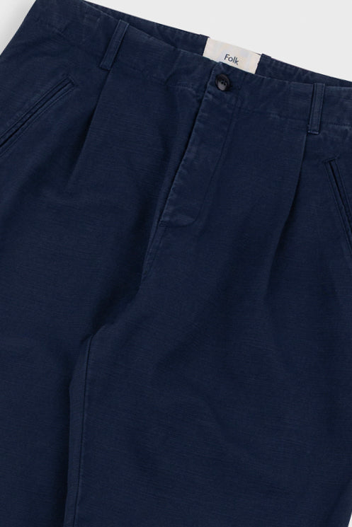 Navy blue pants with a brand label on a white background