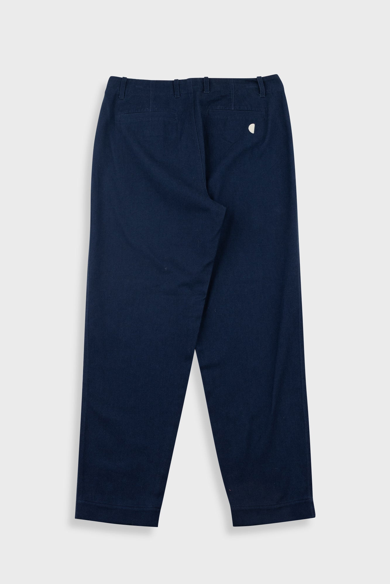 Navy blue pants with a small white logo on a light gray background