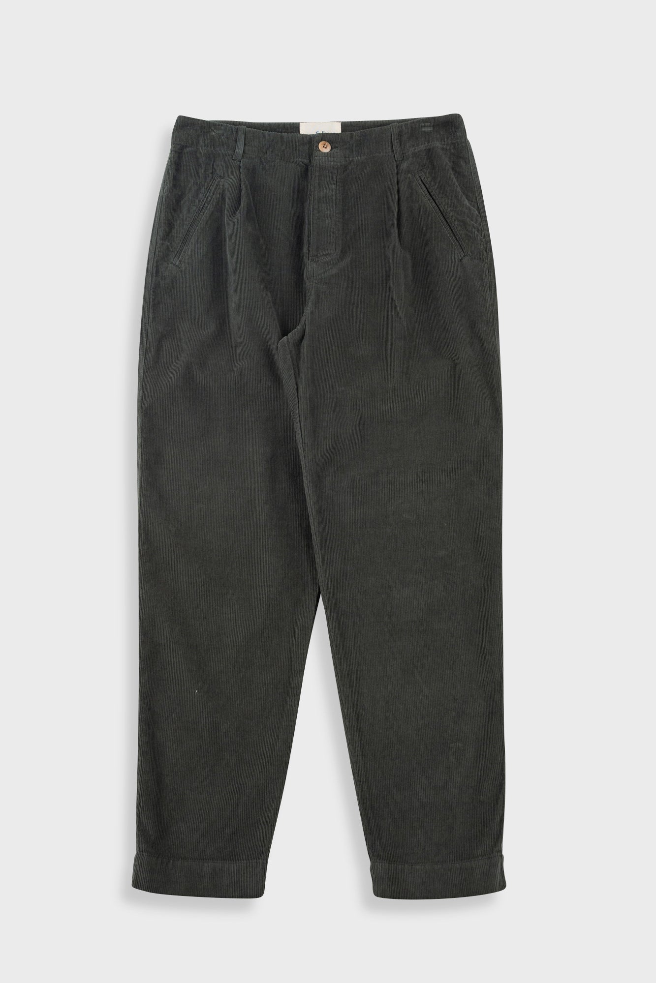 Dark green pleated pants with a close-up on the waistband and pleats.