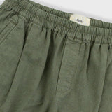 Green pants with an 'Folk' label on a light gray background