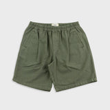 Green shorts on a light gray background