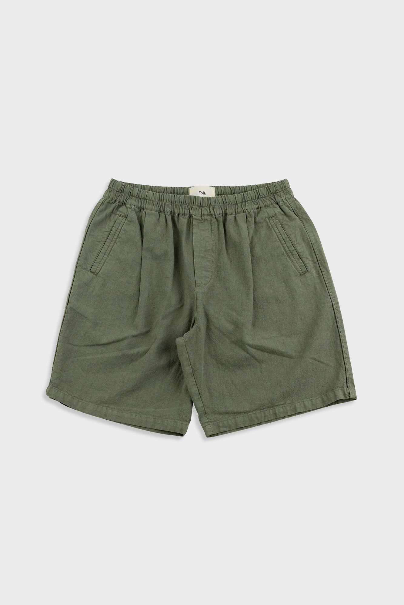 Green shorts on a light gray background