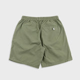 Green shorts with a small logo on a white background