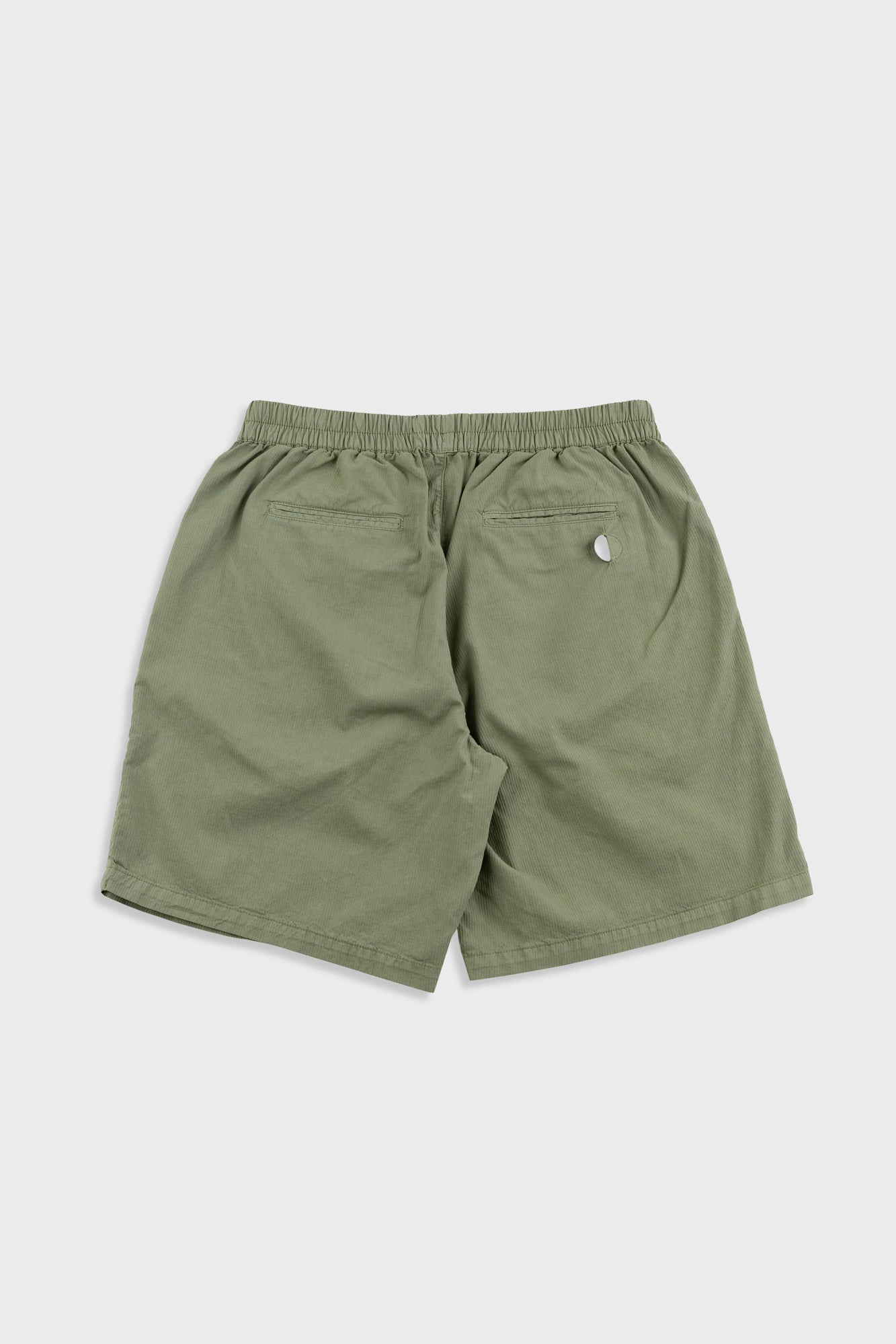 Green shorts with a small logo on a white background