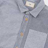 Gray striped shirt with wooden buttons and a visible brand label on a light gray background